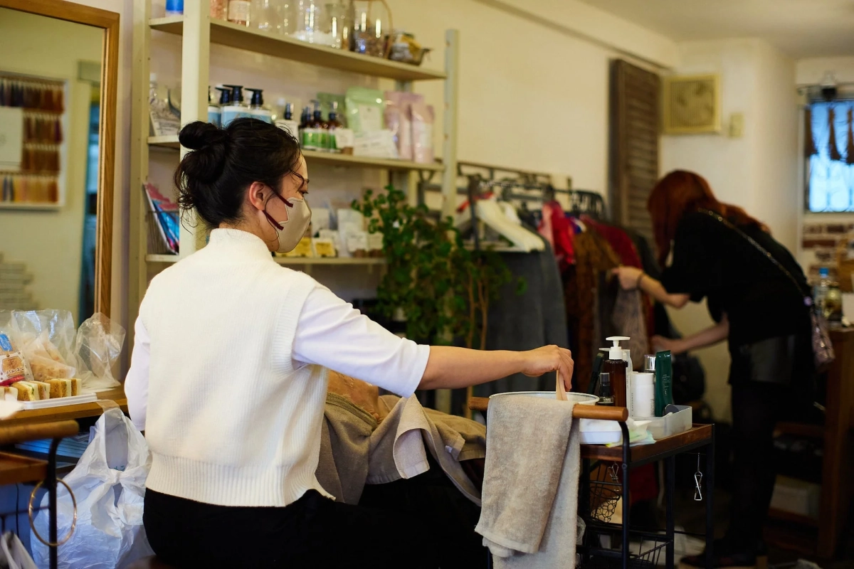 マスクを着用した女性が顧客に美容施術を行っている様子