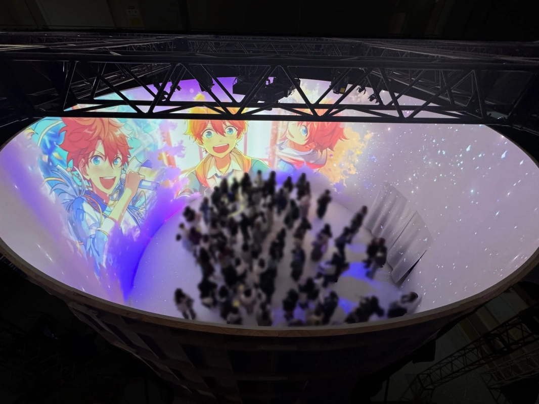 アニメキャラクターが映し出された巨大なプロジェクションマッピングイベントの様子