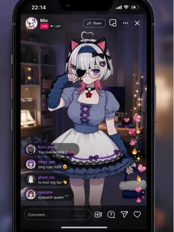 スマートフォン画面に表示されたVTuber「Mio」のライブ配信の様子。猫耳と眼帯が特徴のアニメキャラクターが、青と白を基調としたメイド風の衣装を着ており、視聴者からのコメントが流れています。画面にはハートや炎のエフェクトも表示されています。