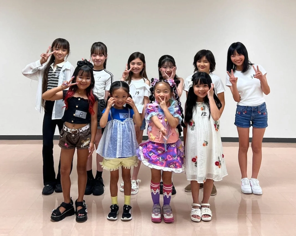 笑顔でピースサインをする女の子たちの集合写真