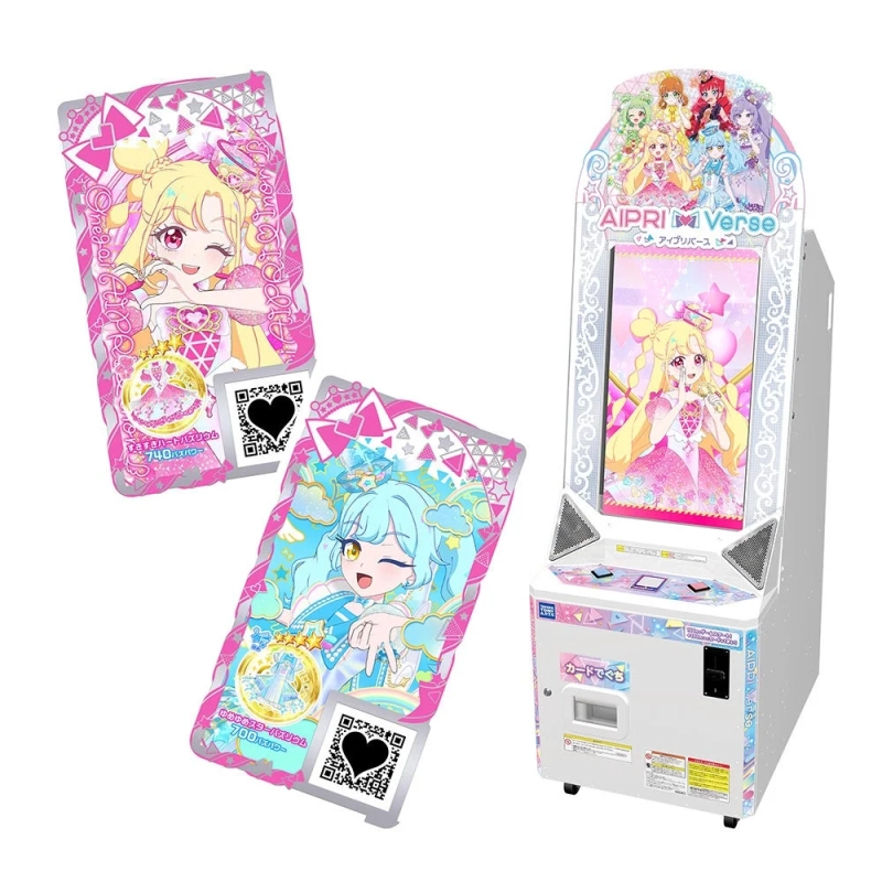 「AIPRI Verse（アイプリバース）」という日本のアーケードゲーム機と、そのゲームで使われる2枚のカラフルなキャラクターカードが写っています。カードには可愛いアニメ風のアイドルキャラクターが描かれ、それぞれ「ささやきハートバリュウム 740パワー」「ゆめかわスターバリュウム 700パワー」というテキストが見られます。