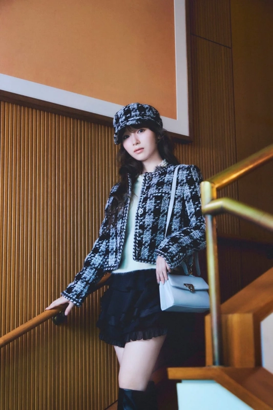 チェック柄ジャケットとショルダーバッグを着用した守屋麗奈さん